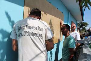 Our team board up windows to limit typhoon damage