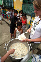 Kids line up for a hot meal