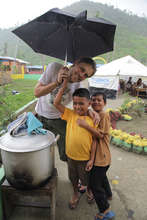 Kids get out of the rain at mobile soup kitchen