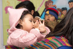 a child on the back of her mother from the project