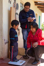 weighing the children to measure their progress