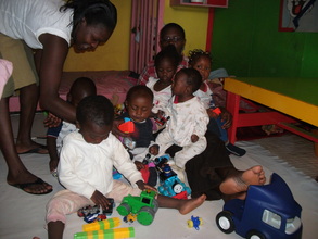 Kids recieving toys delivered by Lilian from UK