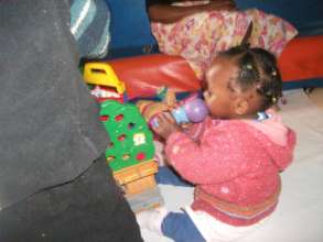A baby on the toy microphone