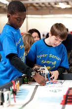 FIRST LEGO League team demonstrating their robot