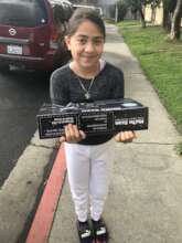 A teen proudly holding her new scooter