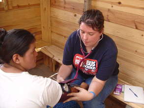 Youth taking vital signs in village clinic