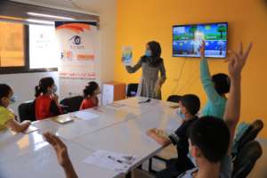 Children with their tutor in the "English CORNER"
