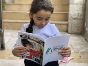 Child from Dheisheh RC reading the ESL's magazine