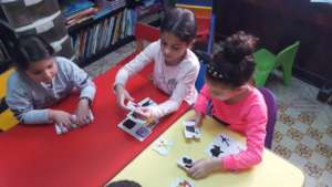 Younger children play with puzzles
