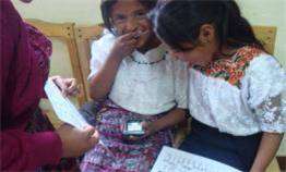 Girls entering coordinanates in positioning device