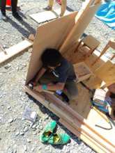 A carpenter making a house