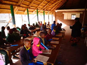 Children learning under a shade