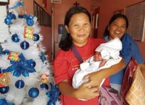 Happy Family with new baby at Christmastime