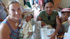 Twins receiving food supplements with check-up