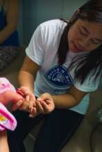 Midwife Nerissa testing baby for metabolic disease