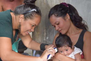 Rina at home visit, checking up mother and baby