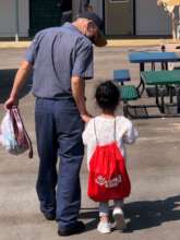 Dad and child with RAR book bag