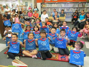 The full graduating class with their new blue bags