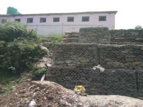 Gabion supporting the school toilet after lanslide