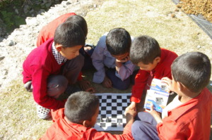 Guranse students enjoying ETC-supplied chess set