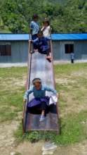 Enjoying the new slide at Gujarpa School, Lapilang