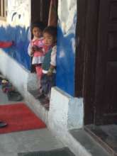 Primary students in their classroom doorway