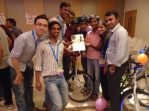 Shubham presenting a greeting card to TATA staff