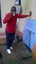 Lawal (YDTP trainer) drinking from the tap