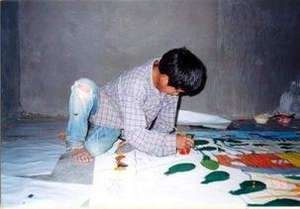 Pima kid painting in a comunitary mural