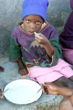 Chizani eating porridge