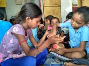 Children learning to count using bottlecaps