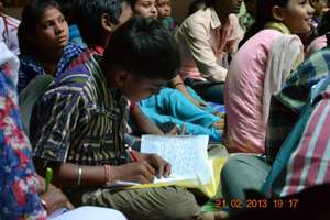 A child taking notes during the manifesto workshop