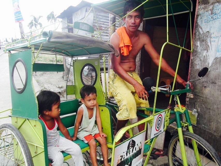 Eugenio takes care of his children while at work.
