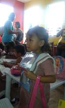 A Day Care girl listening instruction