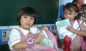 Day Care girls showing their school stuffs