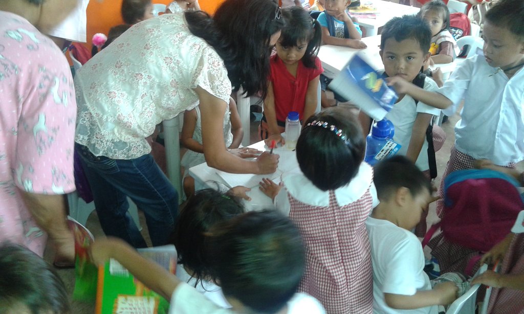 Day Care Worker checking the works of the kids