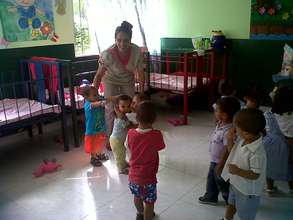 A nursery teacher with her loving students