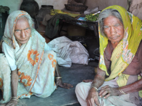 Destitute elderly women getting food provisions