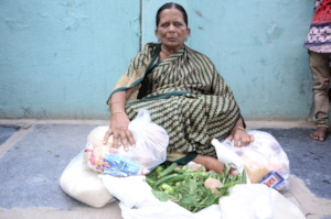 Elderly women groceries donation giving monthly