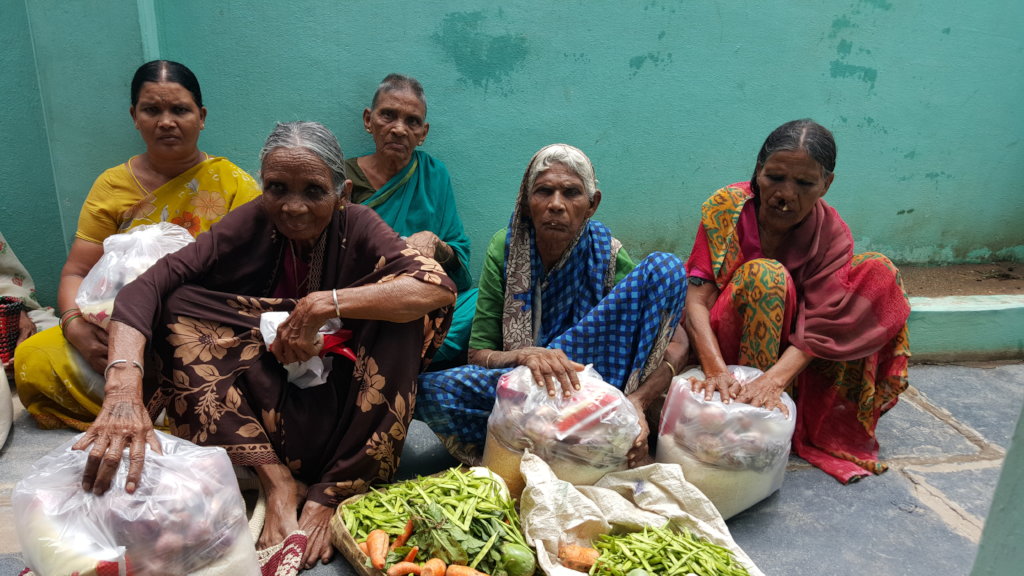 India poor elderly persons getting food support