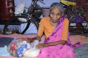Unfortunate elderly person getting food donations_