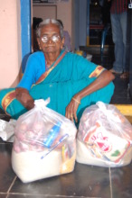 donating groceries for poor older woman in india