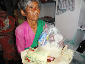 helping elderly woman by giving monthly provisions