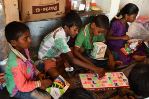 Deprived Children playing with toys donation given