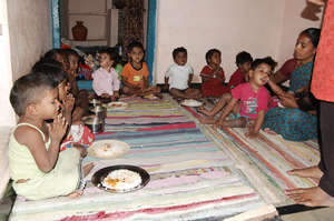 underprivileged kids having meal in daycare center