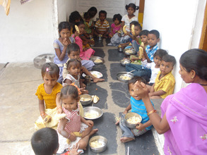 poor kids in day care center are having meals at c