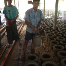 Worker holding the mold, with wet stoves