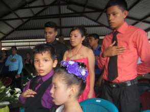 Ninth grade graduates with kindergarten in front