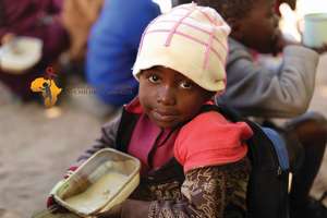 Maria eating porridge at school