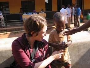 Rwanda Non-clinic Claire, Child and candy